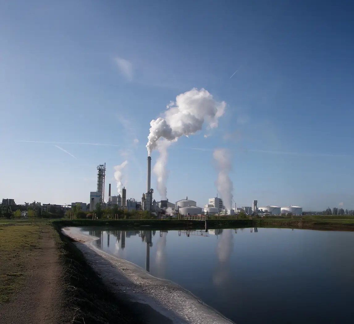 Industriekomplex vor einem Speichersee
